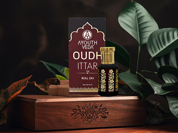 A glass roll-on bottle of Ayouthveda Oudh Ittar, a luxurious fragrance oil 